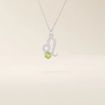 14k solid gold Leo zodiac symbol pendant necklace with a round green peridot, minimalist astrology birthstone jewelry.
