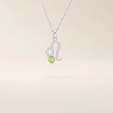 14k solid gold Leo zodiac symbol pendant necklace with a round green peridot, minimalist astrology birthstone jewelry.