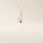 14k solid gold Libra zodiac symbol pendant necklace with a vibrant pink tourmaline. Minimalist astrology birthstone jewelry.