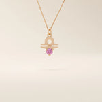 14k solid gold Libra zodiac symbol pendant necklace with a vibrant pink tourmaline. Minimalist astrology birthstone jewelry.