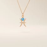 14k solid gold Pisces zodiac symbol pendant necklace with a round aquamarine, minimalist astrology birthstone jewelry.