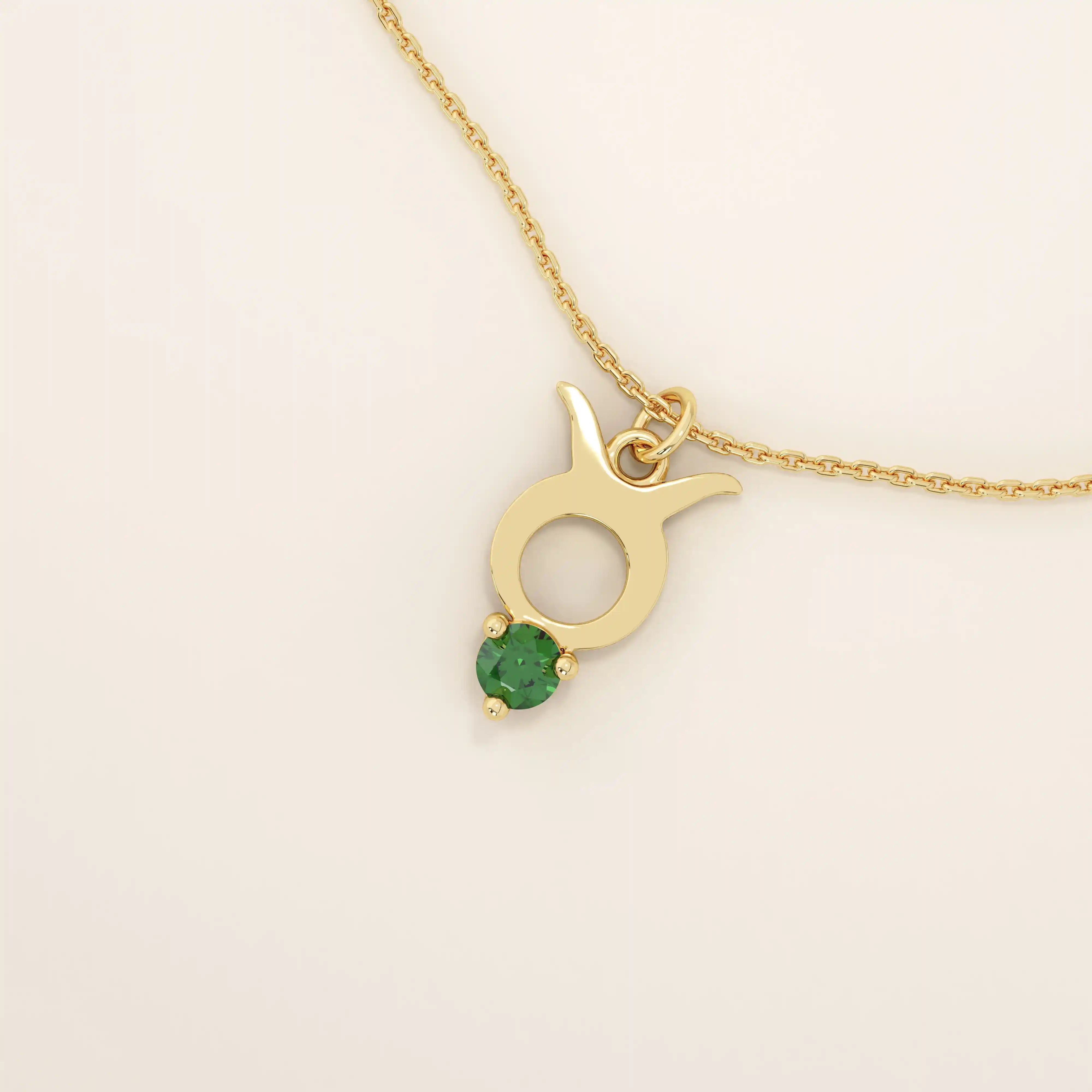 14k solid gold Taurus zodiac pendant necklace with a rich green emerald birthstone. A personalized and elegant zodiac accessory.