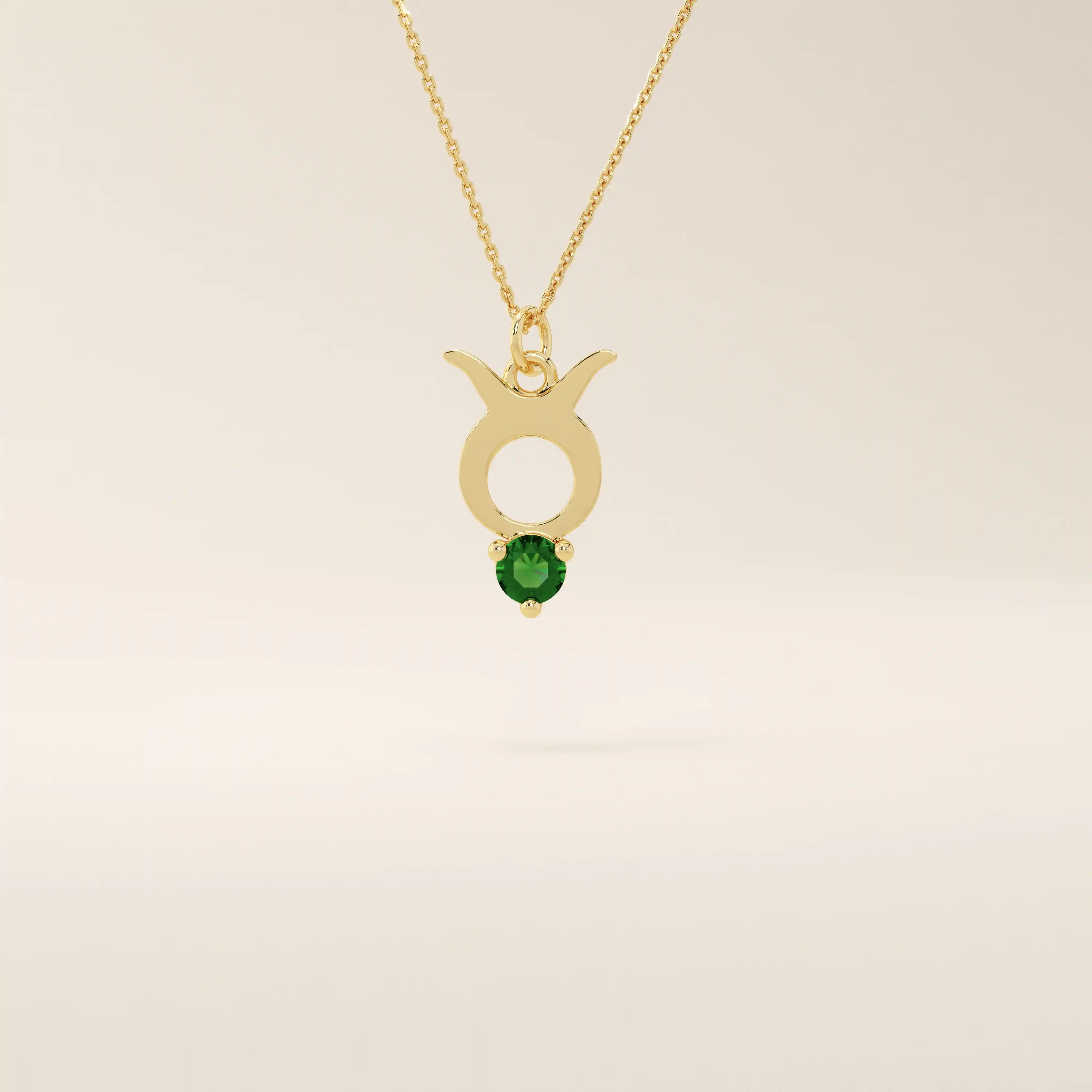 14k solid gold Taurus zodiac pendant necklace with a rich green emerald birthstone. A personalized and elegant zodiac accessory.