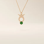 14k solid gold Taurus zodiac pendant necklace with a rich green emerald birthstone. A personalized and elegant zodiac accessory.
