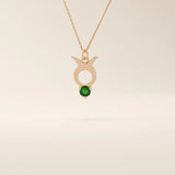 14k solid gold Taurus zodiac pendant necklace with a rich green emerald birthstone. A personalized and elegant zodiac accessory.