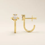 14k solid gold U-shaped stud earrings featuring a front-facing pear-cut moissanite. A unique and modern earring design. Perfect for daily wear or special occasions.