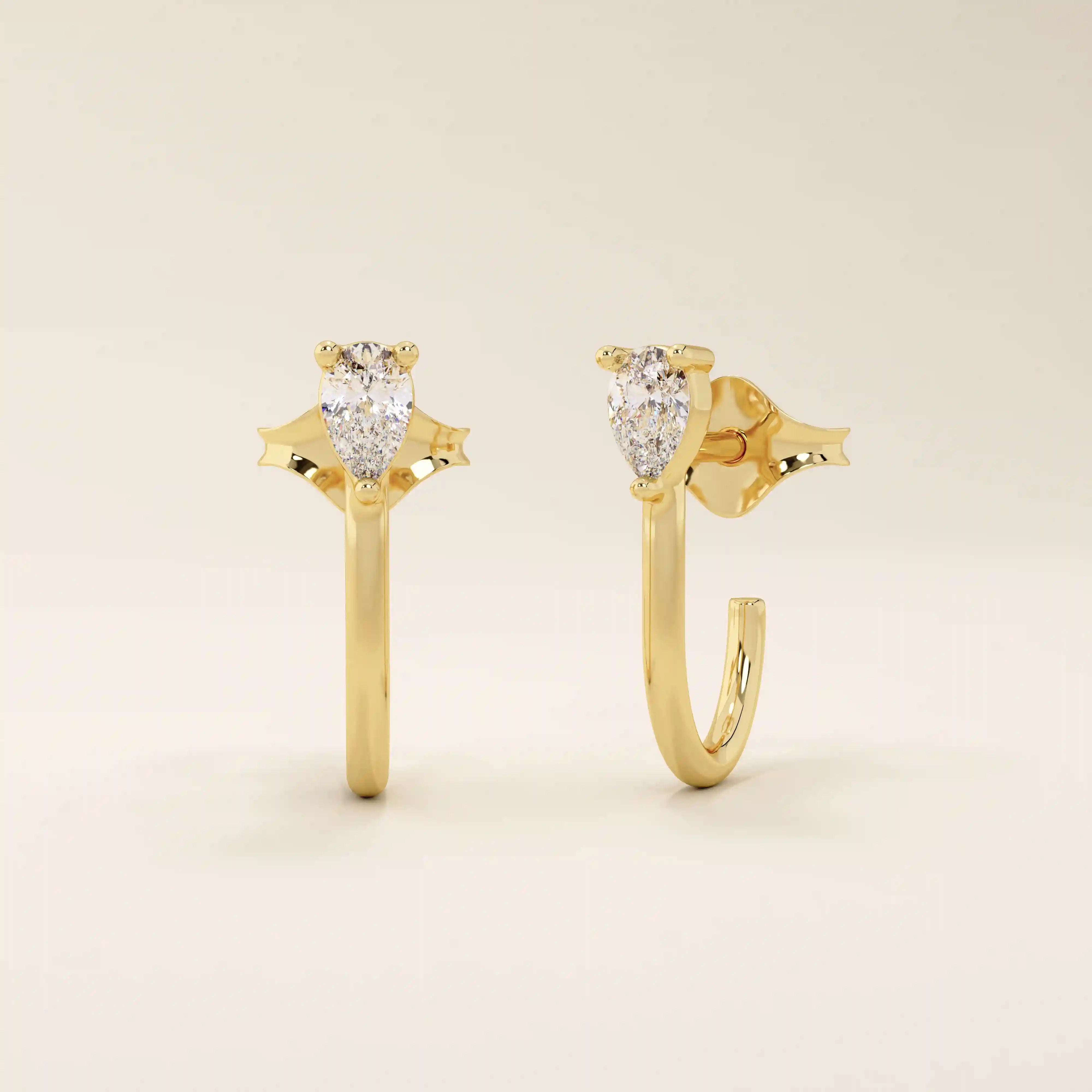 14k solid gold U-shaped stud earrings featuring a front-facing pear-cut moissanite. A unique and modern earring design. Perfect for daily wear or special occasions.