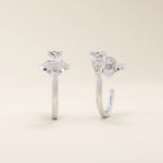14k solid gold U-shaped stud earrings featuring a front-facing pear-cut moissanite. A unique and modern earring design. Perfect for daily wear or special occasions.