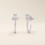 14k solid gold U-shaped stud earrings featuring a front-facing pear-cut moissanite. A unique and modern earring design. Perfect for daily wear or special occasions.