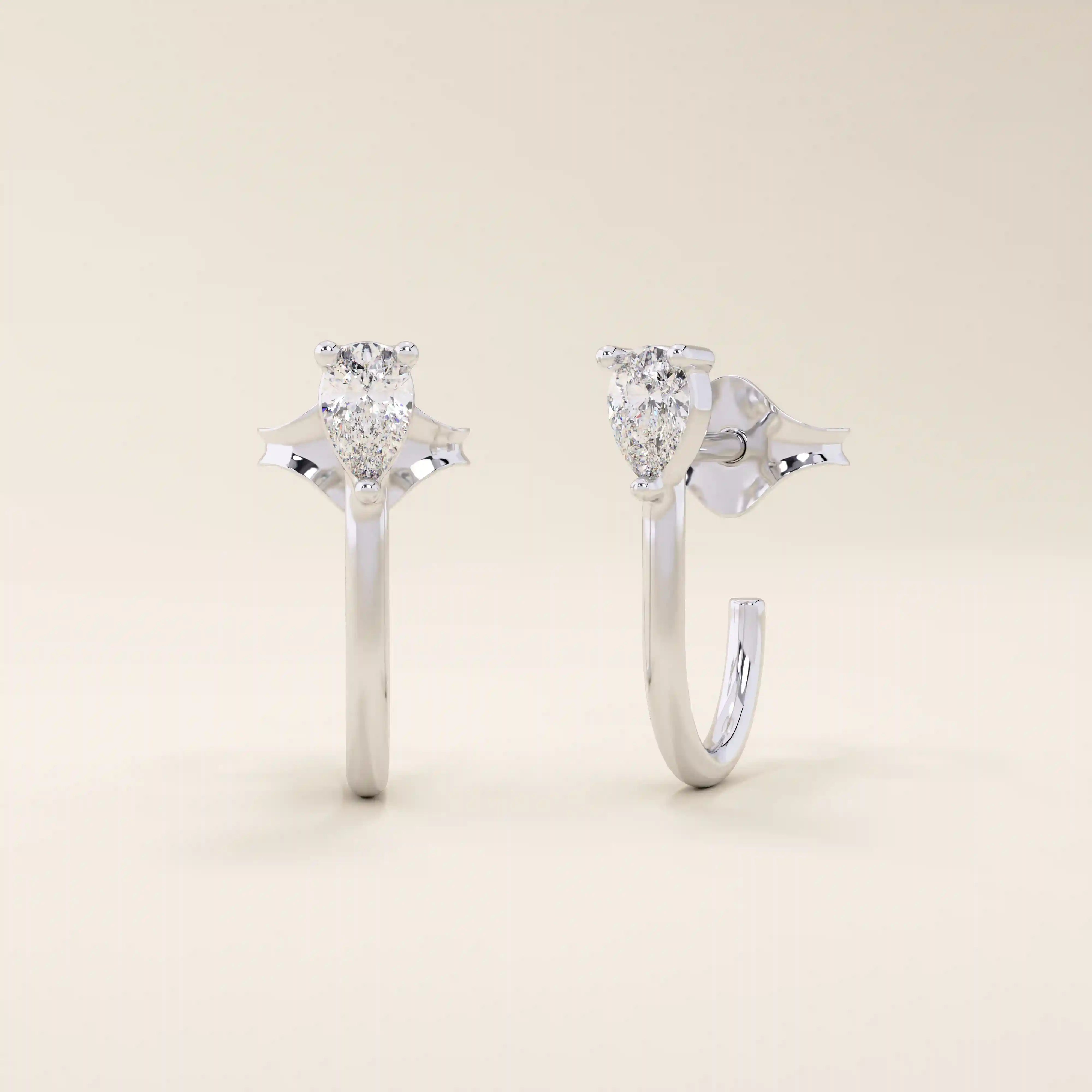 14k solid gold U-shaped stud earrings featuring a front-facing pear-cut moissanite. A unique and modern earring design. Perfect for daily wear or special occasions.