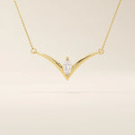 14k solid gold V-shape necklace with a marquise-cut moissanite at the center. Unique and modern gold necklace design. Dainty and minimalist jewelry for everyday wear.