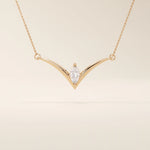 14k solid gold V-shape necklace with a marquise-cut moissanite at the center. Unique and modern gold necklace design. Dainty and minimalist jewelry for everyday wear.