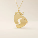 14k solid gold baby foot pendant necklace featuring a delicate tiny moissanite accent. A sentimental jewelry piece symbolizing new beginnings or motherhood. Perfect for gifting or everyday wear.