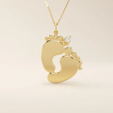 14k solid gold baby foot pendant necklace featuring a delicate tiny moissanite accent. A sentimental jewelry piece symbolizing new beginnings or motherhood. Perfect for gifting or everyday wear.