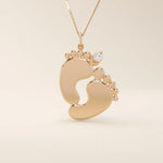 14k solid gold baby foot pendant necklace featuring a delicate tiny moissanite accent. A sentimental jewelry piece symbolizing new beginnings or motherhood. Perfect for gifting or everyday wear.