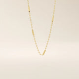 14k solid gold bar chain necklace with sleek horizontal links and a polished finish. A modern and minimal gold chain. Great for layering or wearing alone.