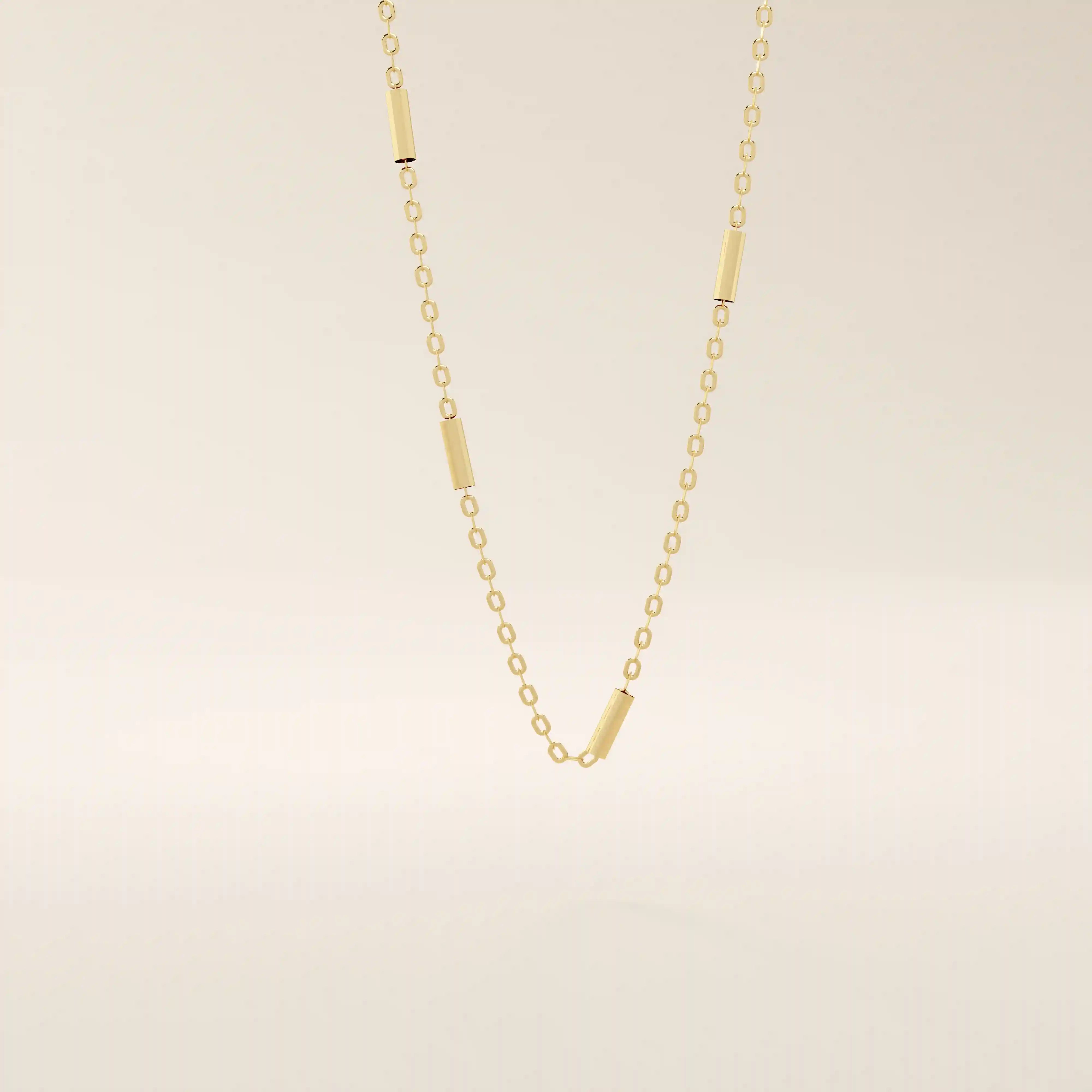 14k solid gold bar chain necklace with sleek horizontal links and a polished finish. A modern and minimal gold chain. Great for layering or wearing alone.
