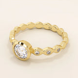 14k solid gold bezel-set solitaire engagement ring featuring a round moissanite and subtle detailing along the band. A modern twist on a classic style. Perfect for timeless proposals.