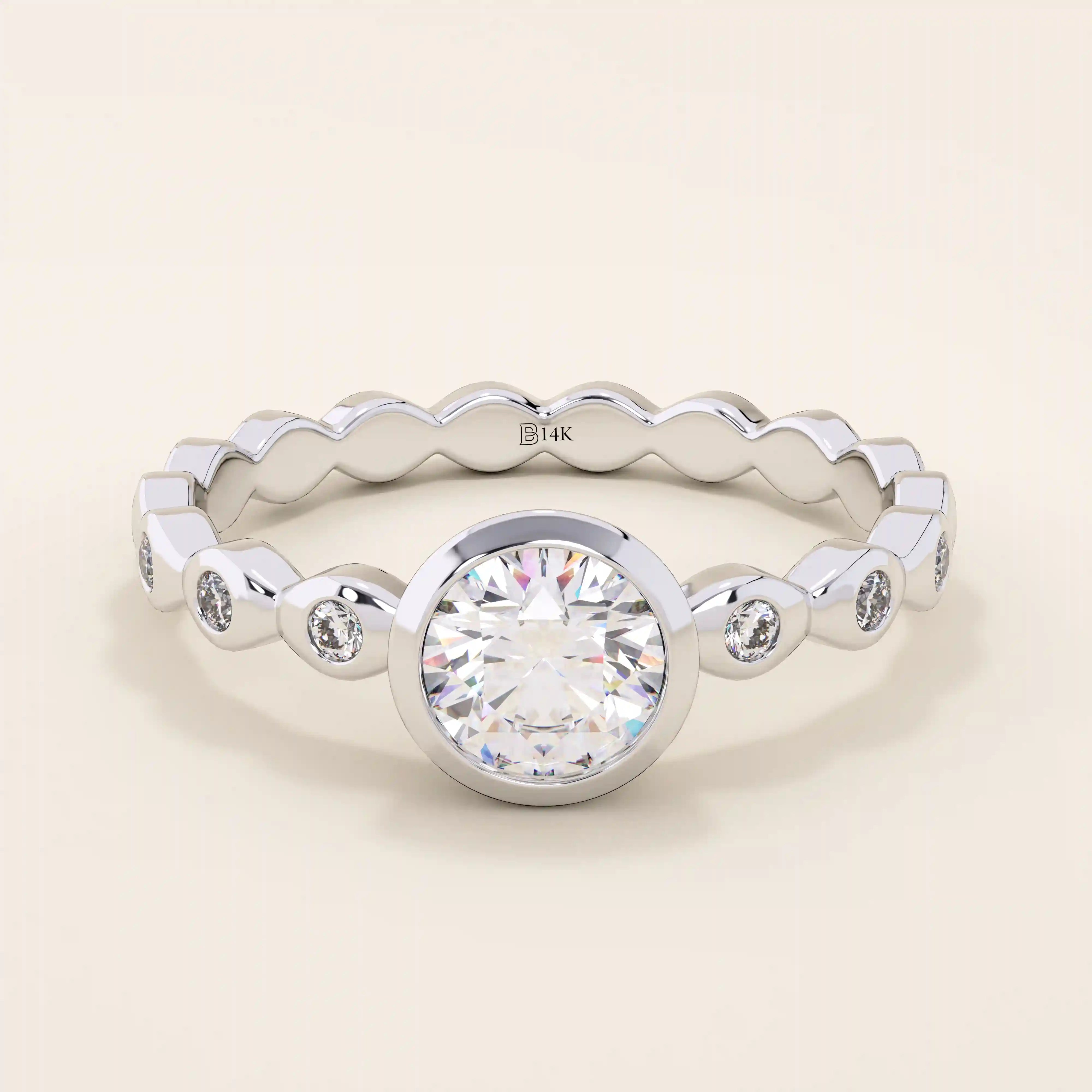 14k solid gold bezel-set solitaire engagement ring featuring a round moissanite and subtle detailing along the band. A modern twist on a classic style. Perfect for timeless proposals.
