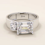 14k solid gold bold chunky Toi et Moi engagement ring featuring a prong-set emerald-cut moissanite and round-cut moissanites half bezel set. Modern, statement bridal design.
