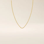 14k solid gold box chain necklace with square-shaped links and a smooth finish. A timeless and durable gold chain. Ideal for daily wear or layering.