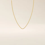 14k solid gold box chain necklace with square-shaped links and a smooth finish. A timeless and durable gold chain. Ideal for daily wear or layering.