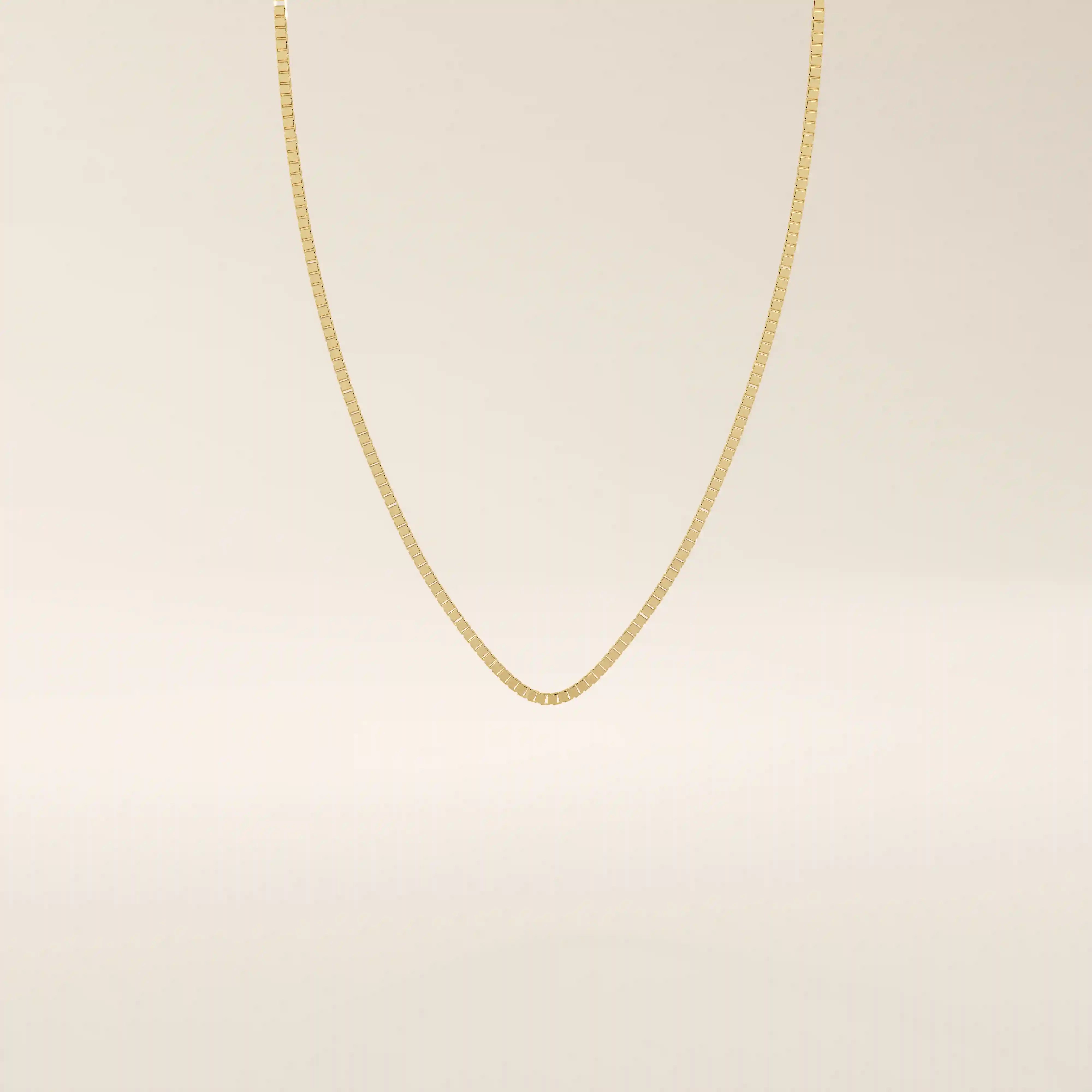 14k solid gold box chain necklace with square-shaped links and a smooth finish. A timeless and durable gold chain. Ideal for daily wear or layering.