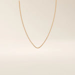 14k solid gold box chain necklace with square-shaped links and a smooth finish. A timeless and durable gold chain. Ideal for daily wear or layering.