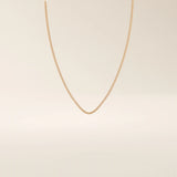 14k solid gold box chain necklace with square-shaped links and a smooth finish. A timeless and durable gold chain. Ideal for daily wear or layering.