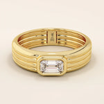 14k solid gold chunky engagement ring with a thick band, featuring bezel-set emerald-cut moissanites lining the band. Bold and modern design for statement bridal jewelry.