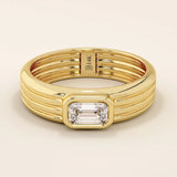14k solid gold chunky engagement ring with a thick band, featuring bezel-set emerald-cut moissanites lining the band. Bold and modern design for statement bridal jewelry.