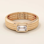 14k solid gold chunky engagement ring with a thick band, featuring bezel-set emerald-cut moissanites lining the band. Bold and modern design for statement bridal jewelry.
