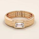 14k solid gold chunky engagement ring with a thick band, featuring bezel-set emerald-cut moissanites lining the band. Bold and modern design for statement bridal jewelry.