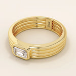 14k solid gold chunky engagement ring with a thick band, featuring bezel-set emerald-cut moissanites lining the band. Bold and modern design for statement bridal jewelry.