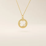 14k solid gold circle pendant necklace featuring a clover-shaped cutout and a single sparkling moissanite. Symbolic and delicate design.
