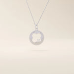 14k solid gold circle pendant necklace featuring a clover-shaped cutout and a single sparkling moissanite. Symbolic and delicate design.