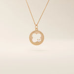 14k solid gold circle pendant necklace featuring a clover-shaped cutout and a single sparkling moissanite. Symbolic and delicate design.