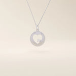 14k solid gold circle pendant necklace featuring a heart-shaped cutout and a single sparkling moissanite. Delicate and meaningful design.
