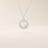 14k solid gold circle pendant necklace featuring a heart-shaped cutout and a single sparkling moissanite. Delicate and meaningful design.