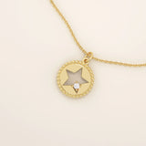 14k solid gold circle pendant necklace featuring a star-shaped cutout and a single sparkling moissanite. Delicate and celestial-inspired design.