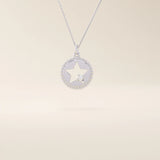 14k solid gold circle pendant necklace featuring a star-shaped cutout and a single sparkling moissanite. Delicate and celestial-inspired design.