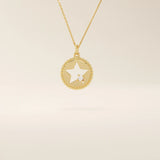 14k solid gold circle pendant necklace featuring a star-shaped cutout and a single sparkling moissanite. Delicate and celestial-inspired design.