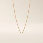 14k solid gold curb chain necklace with flat, closely interlocked links and a polished finish. A timeless and sturdy gold chain. Ideal for everyday wear or layering.