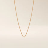 14k solid gold curb chain necklace with flat, closely interlocked links and a polished finish. A timeless and sturdy gold chain. Ideal for everyday wear or layering.