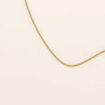 14k solid gold curb chain necklace with flat, closely interlocked links and a polished finish. A timeless and sturdy gold chain. Ideal for everyday wear or layering.