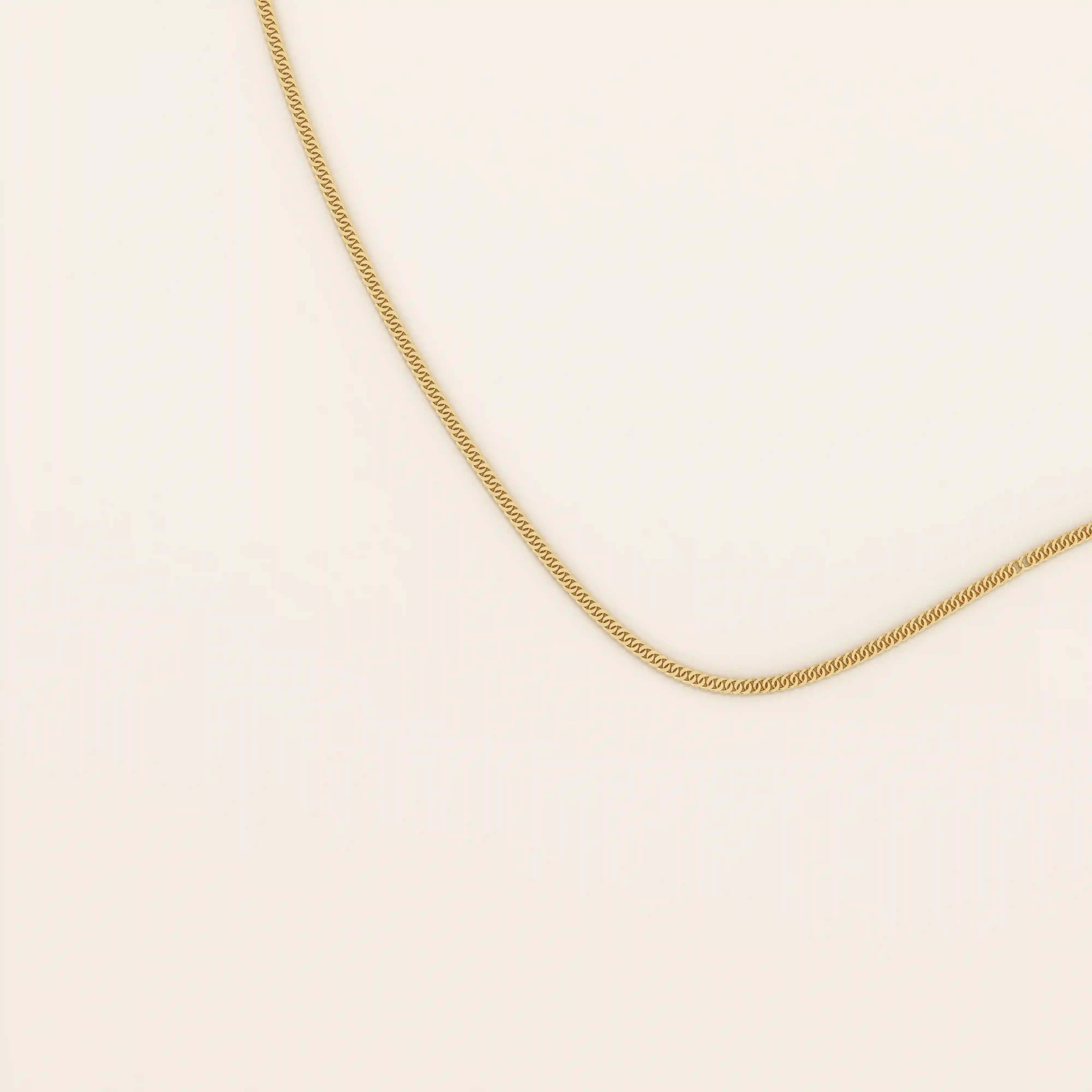14k solid gold curb chain necklace with flat, closely interlocked links and a polished finish. A timeless and sturdy gold chain. Ideal for everyday wear or layering.