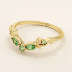 14k solid gold curve nesting ring featuring a marquise-cut emerald gemstone. Elegant and modern stacking design for women.