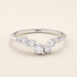 14k solid gold curved nesting ring featuring a cluster of sparkling moissanites. A delicate and elegant stacking ring with organic design.
