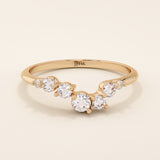 14k solid gold curved nesting ring featuring a cluster of sparkling moissanites. A delicate and elegant stacking ring with organic design.