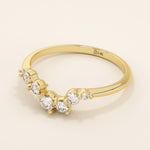 14k solid gold curved nesting ring featuring a cluster of sparkling moissanites. A delicate and elegant stacking ring with organic design.